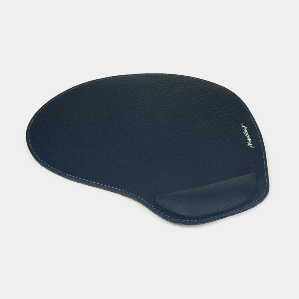Blue leather mouse pad, side view of the padded wrist rest and stitched edge