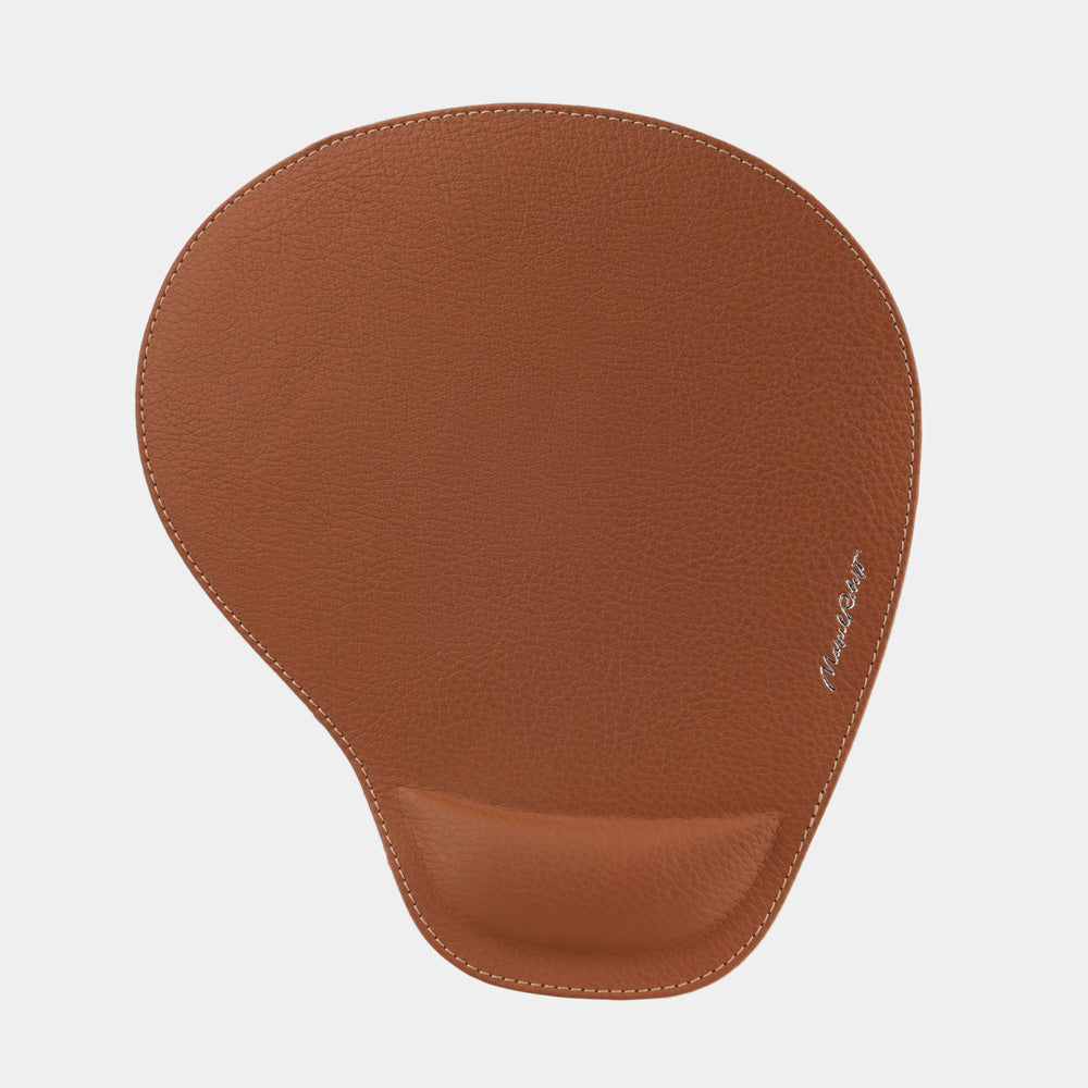 Gold leather mouse pad seen from above, teardrop shape and embossed signature