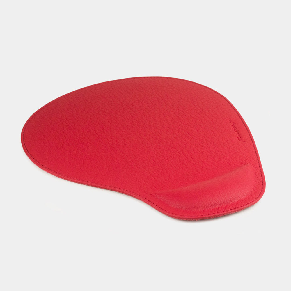 Red leather mouse pad, side view of the padded wrist rest and stitched edge
