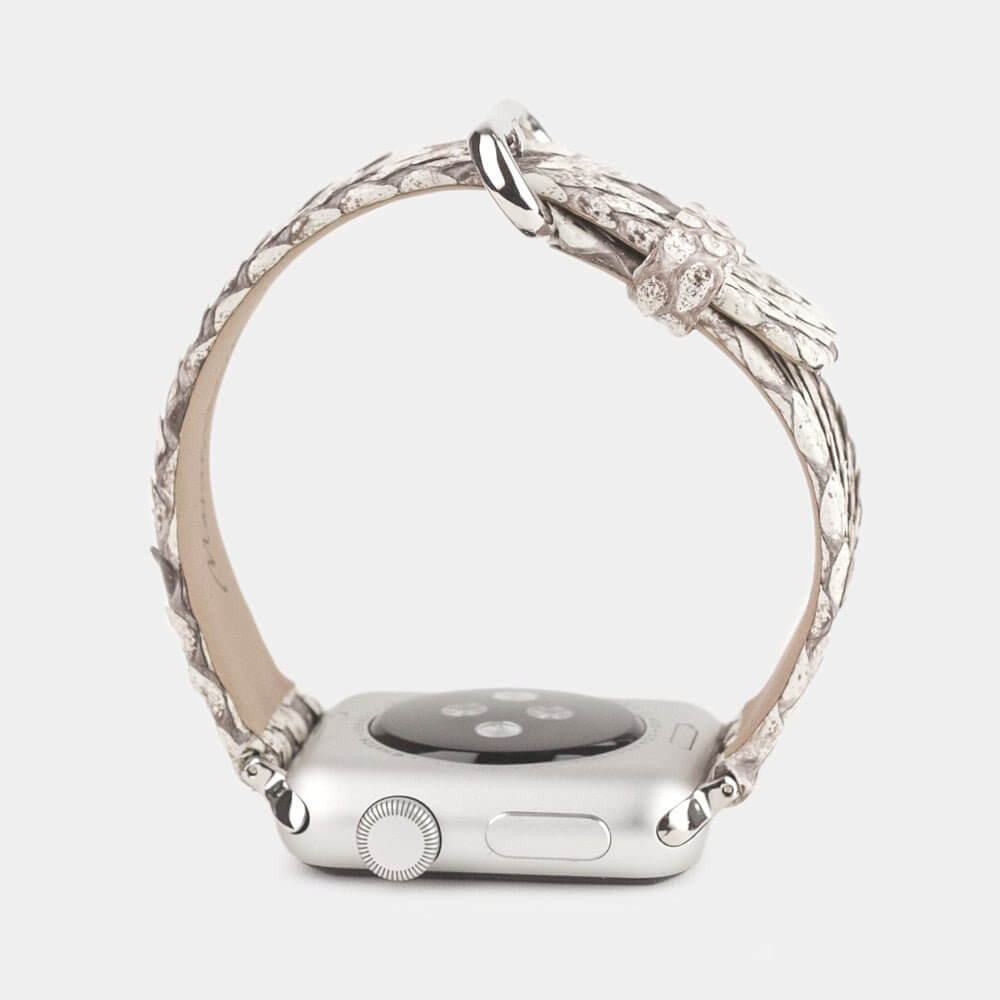 Strap for the Apple Watch 41/42 mm in natural python leather, with steel adapters and buckle | watch case on bottom to see leather texture, inner lining and the buckle