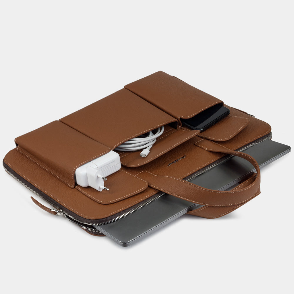 17 inch leather laptop bag with pockets gold holding laptop, charger and documents, professional layout