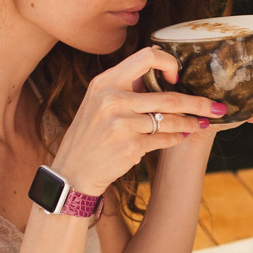 Strap for the Apple Watch 45/46 mm in purple shiny alligator leather, with steel adapters and buckle | lifestyle photo, the strap worn on a woman's wrist