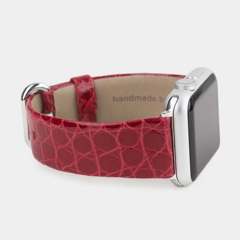 Strap for the Apple Watch 45/46 mm in red shiny alligator leather, with steel adapters and buckle | close-up on the inner lining leather and the brand stamp