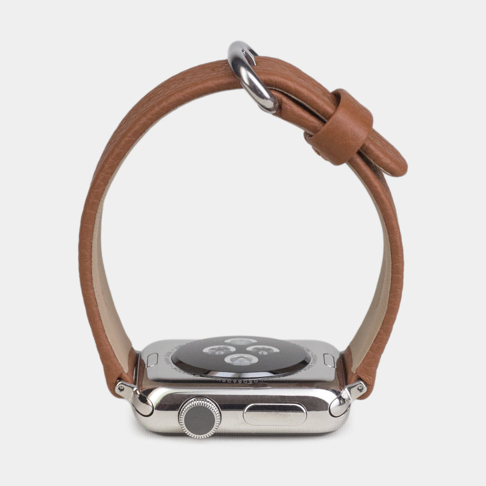 Strap for the Apple Watch 41/42 mm in Gold soft grained calfskin leather, with steel adapters and buckle | watch case on bottom to see leather texture, inner lining and the buckle