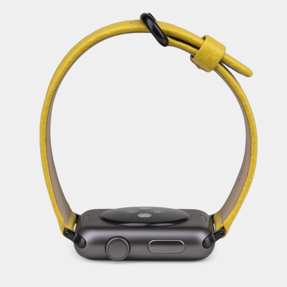 Strap for the Apple Watch 41/42 mm in yellow soft grained calfskin leather, with black adapters and buckle | watch case on bottom to see leather texture, inner lining and the buckle
