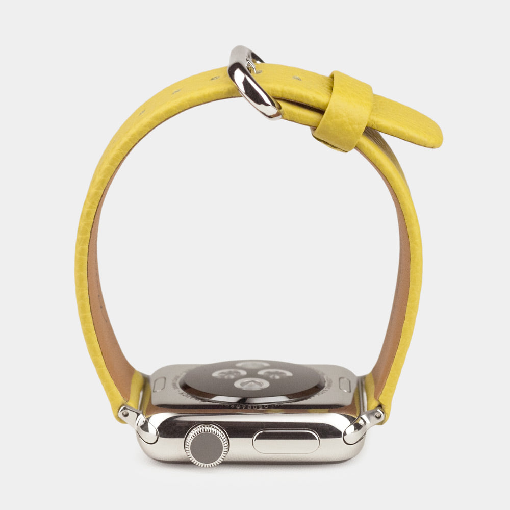 Strap for the Apple Watch 41/42 mm in yellow soft grained calfskin leather, with steel adapters and buckle | watch case on bottom to see leather texture, inner lining and the buckle