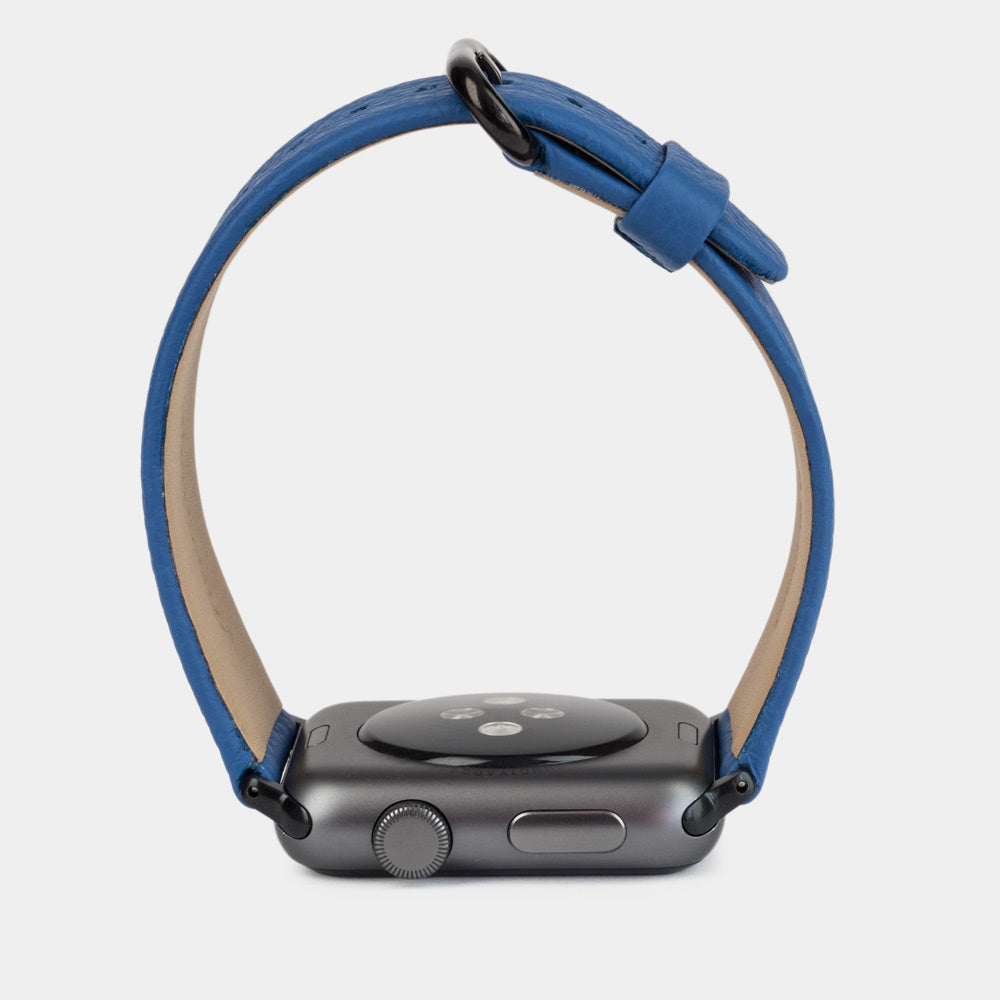Strap for the Apple Watch 41/42 mm in royal blue soft grained calfskin leather, with black adapters and buckle | watch case on bottom to see leather texture, inner lining and the buckle
