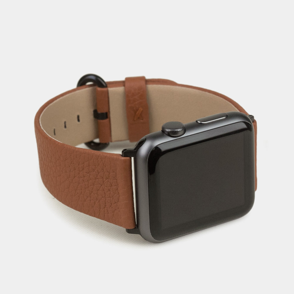 Strap for the Apple Watch 41/42 mm in Gold soft grained calfskin leather, with black adapters and buckle | watch case on bottom to see leather texture, inner lining and the buckle