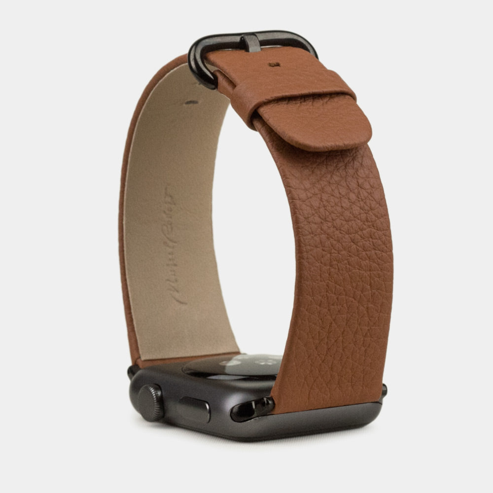 Strap for the Apple Watch 41/42 mm in Gold soft grained calfskin leather, with black adapters and buckle | front view of the strap looped around the watch case