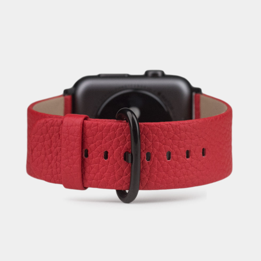 Strap for the Apple Watch 41/42 mm in red soft grained calfskin leather, with black adapters and buckle | watch case on bottom to see leather texture, inner lining and the buckle
