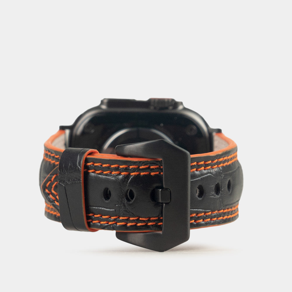 Apple Watch Ultra 49 mm in black alligator leather with orange stitching and edge, with black adapters and buckle | main image