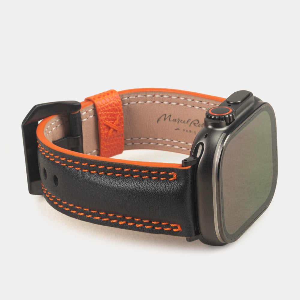 Men's Apple Watch Ultra band 49mm in black smooth calfskin leather with orange edge finish and its black color adapters - 3/4 profile view