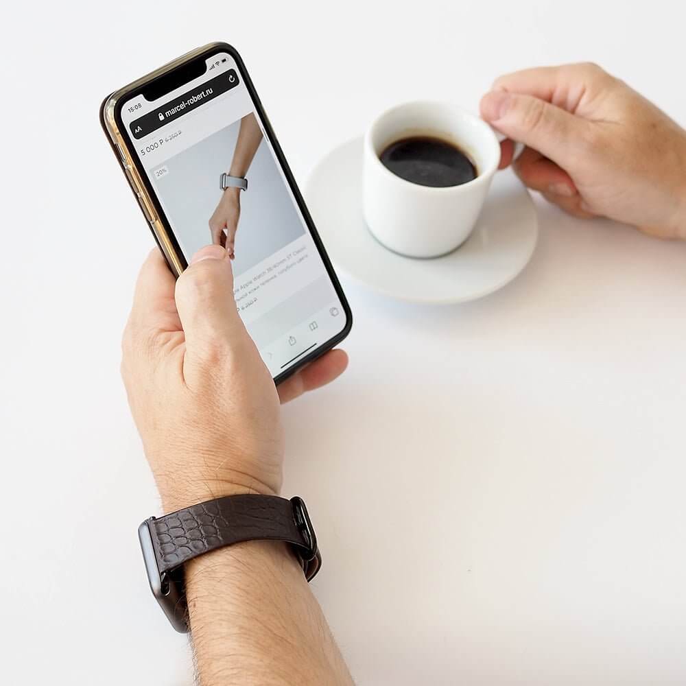 Strap for the Apple Watch 45/46 mm in black matte alligator leather, with black adapters and buckle | lifestyle photo, the strap worn on a man's wrist