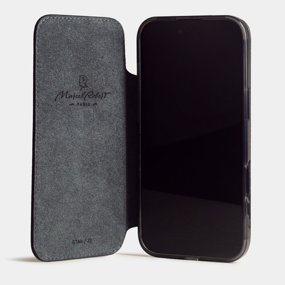 black leather wallet case iPhone 17 - case with grey Alcantara lining shown open on smartphone