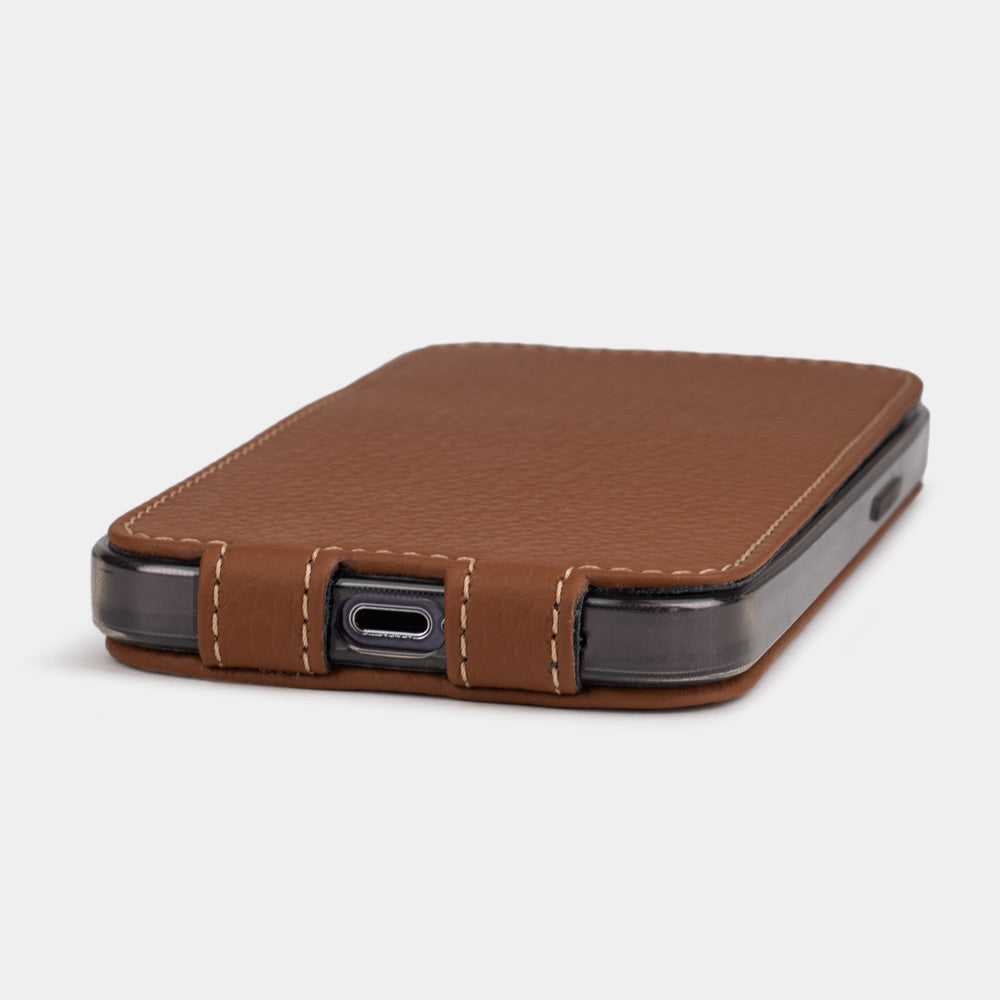 iPhone 14 Pro flip case made with gold premium leather – the case laid flat on the table, showing its slimness and the beauty of the leather grain